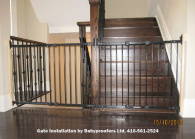 Two large black baby gates across stair openings.